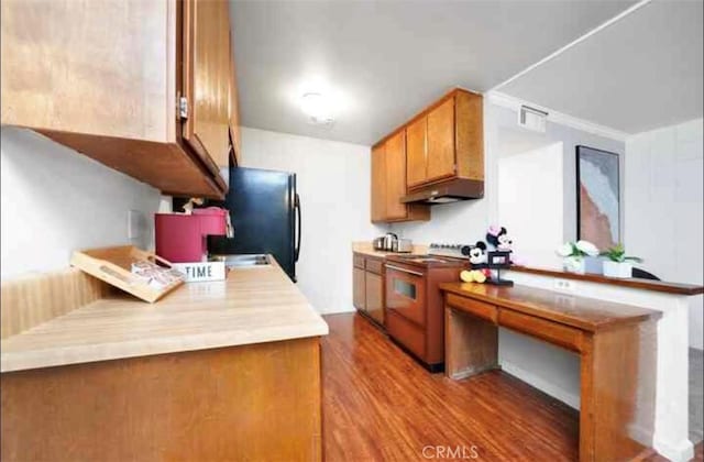 23617 Golden Springs Dr Unit K18, Diamond Bar, CA 91765 - kitchen featuring high end stainless steel range oven, under cabinet range hood, wood finished floors, brown cabinetry, and freestanding refrigerator