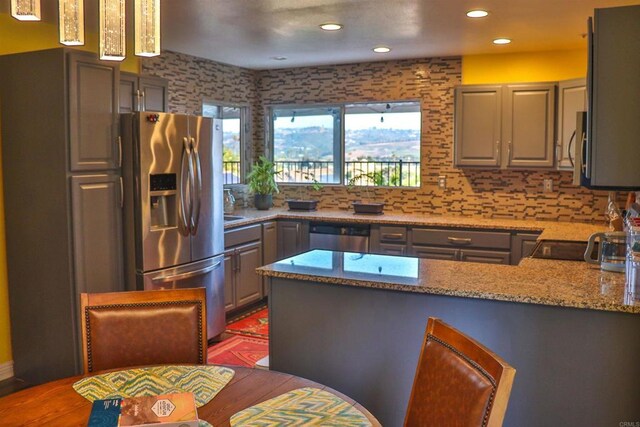 5787 Barbary Pl, Bonsall, CA 92003 - kitchen featuring appliances with stainless steel finishes, gray cabinetry, a peninsula, light stone counters, and recessed lighting