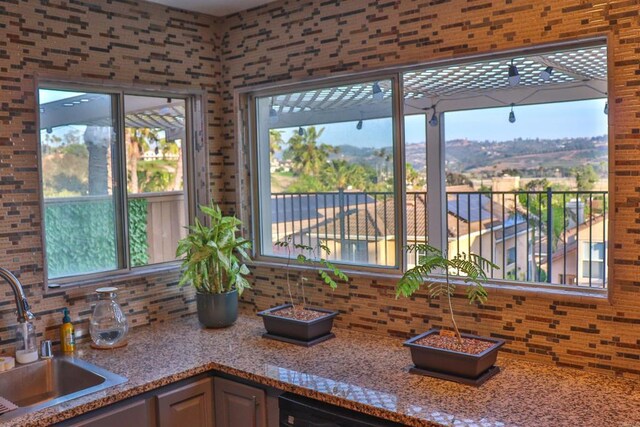 5787 Barbary Pl, Bonsall, CA 92003 - kitchen view of a sink, backsplash, and light stone countertops