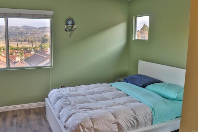5787 Barbary Pl, Bonsall, CA 92003 - bedroom with wood finished floors, multiple windows, and baseboards