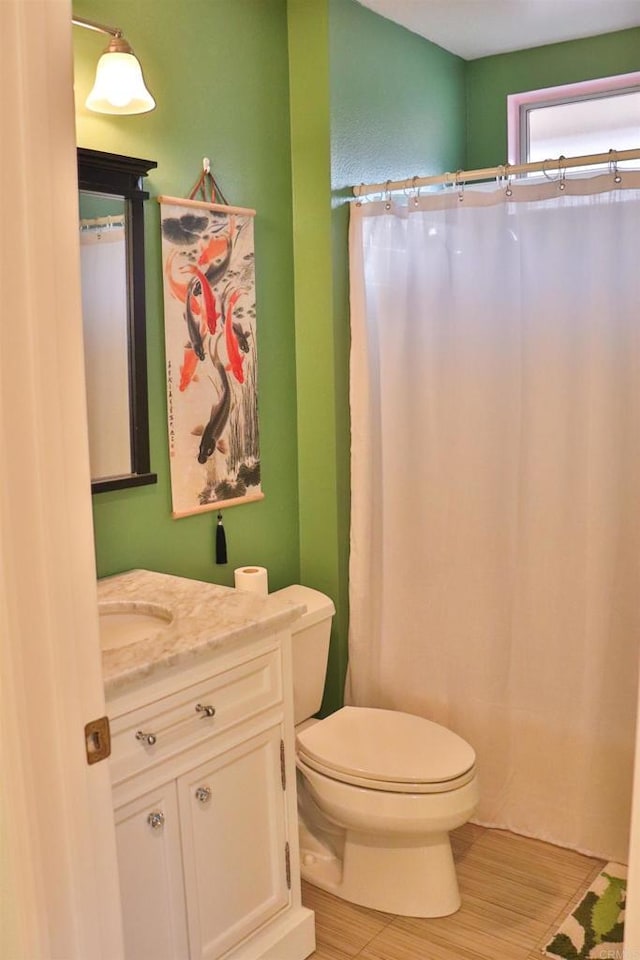 5787 Barbary Pl, Bonsall, CA 92003 - bathroom with wood finished floors, toilet, vanity, and curtained shower