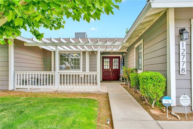 12778 Desert Creek Cir, Victorville, CA 92395 - doorway to property featuring a pergola, a porch, and a yard