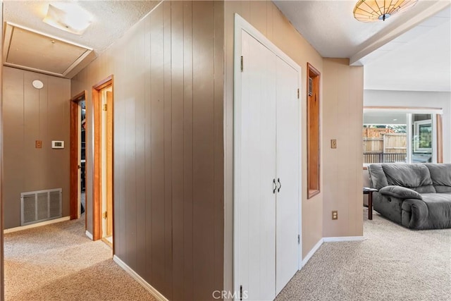 30955 Scenic Way, Running Springs, CA 92382 - hall featuring carpet flooring, attic access, baseboards, and wood walls