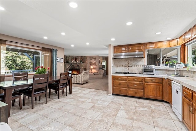 30955 Scenic Way, Running Springs, CA 92382 - kitchen with dishwasher, under cabinet range hood, recessed lighting, a fireplace, and light countertops