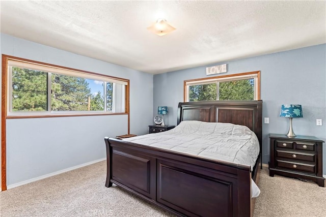30955 Scenic Way, Running Springs, CA 92382 - bedroom with light carpet, multiple windows, a textured ceiling, and baseboards