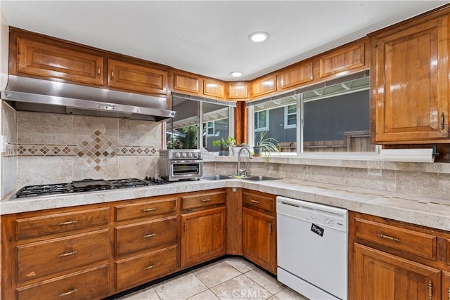 30955 Scenic Way, Running Springs, CA 92382 - kitchen featuring dishwasher, a sink, stainless steel gas stovetop, under cabinet range hood, and light tile patterned floors