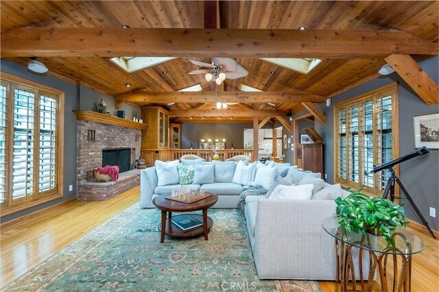 2410 W Cinco Casitas Ln, La Crescenta, CA 91214 - living area with a skylight, wood ceiling, wood finished floors, ceiling fan, and a fireplace