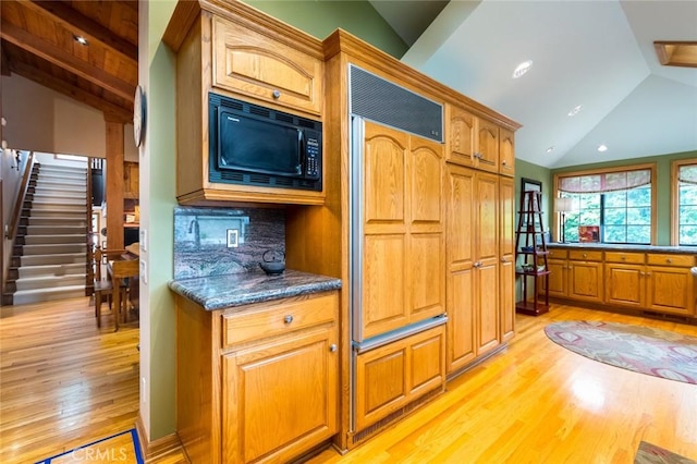 2410 W Cinco Casitas Ln, La Crescenta, CA 91214 - kitchen featuring built in appliances, lofted ceiling, light wood-style floors, dark countertops, and backsplash
