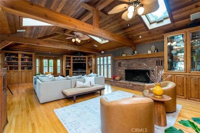 2410 W Cinco Casitas Ln, La Crescenta, CA 91214 - living area featuring a skylight, a ceiling fan, a brick fireplace, wood finished floors, and wooden ceiling