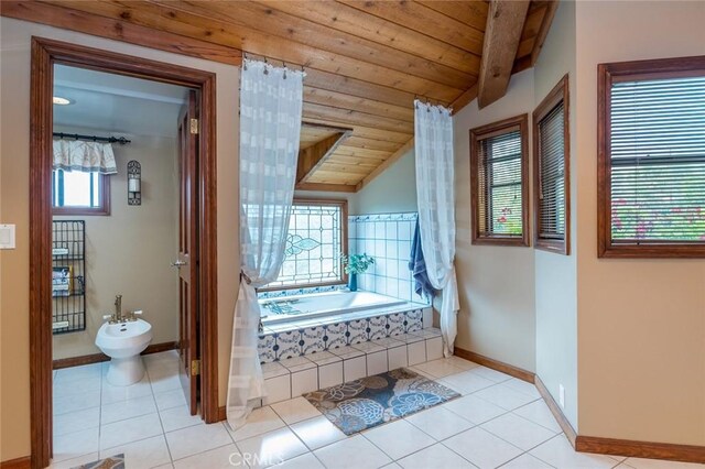 2410 W Cinco Casitas Ln, La Crescenta, CA 91214 - full bathroom with a bidet, lofted ceiling, tile patterned flooring, baseboards, and tiled bath