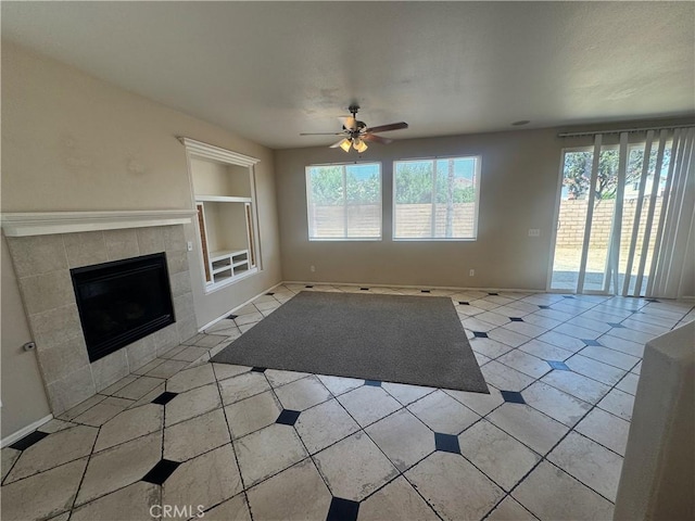 531 Corte, San Pablo, Perris, CA 92571 - unfurnished living room with healthy amount of natural light, built in shelves, a ceiling fan, and a tiled fireplace