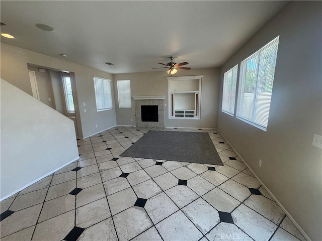 531 Corte, San Pablo, Perris, CA 92571 - unfurnished living room with healthy amount of natural light, a ceiling fan, light tile patterned floors, and baseboards