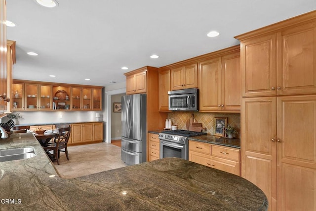 1045 Rotella St, Newbury Park, CA 91320 - kitchen with appliances with stainless steel finishes, decorative backsplash, dark stone countertops, recessed lighting, and brown cabinets