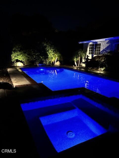 1045 Rotella St, Newbury Park, CA 91320 - pool at twilight featuring an in-ground hot tub and an outdoor pool