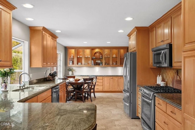 1045 Rotella St, Newbury Park, CA 91320 - kitchen with stainless steel appliances, recessed lighting, dark stone counters, backsplash, and glass insert cabinets