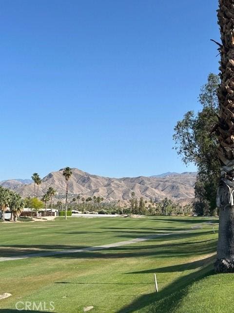 61765 Arroyo Rd Unit 5, Palm Springs, CA 92264 - surrounding community with a mountain view, view of golf course, and a lawn