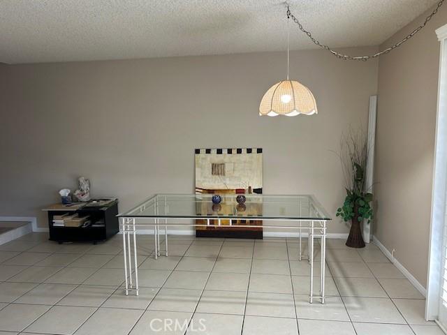 61765 Arroyo Rd Unit 5, Palm Springs, CA 92264 - tiled dining area with a textured ceiling and baseboards