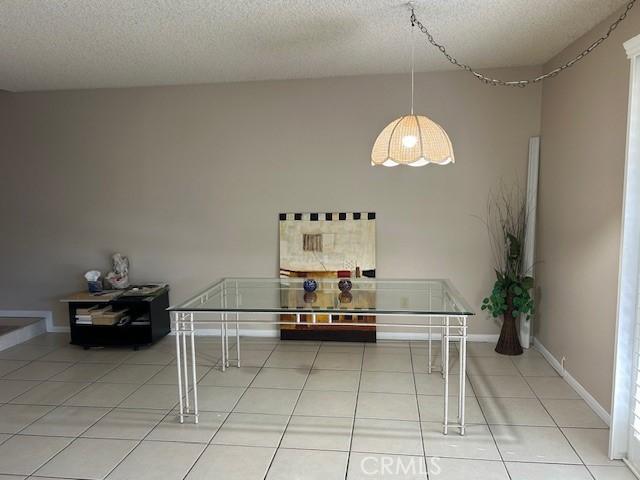 61765 Arroyo Rd Unit 5, Palm Springs, CA 92264 - tiled dining room with a textured ceiling and baseboards