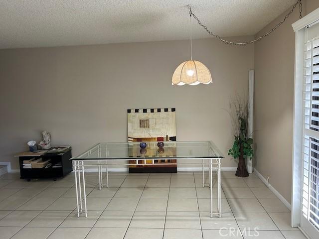 61765 Arroyo Rd Unit 5, Palm Springs, CA 92264 - tiled dining room with a textured ceiling and baseboards