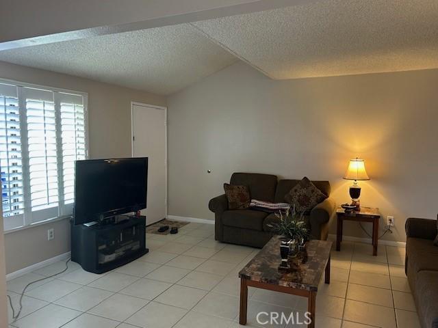 61765 Arroyo Rd Unit 5, Palm Springs, CA 92264 - living area with a textured ceiling, plenty of natural light, and light tile patterned floors