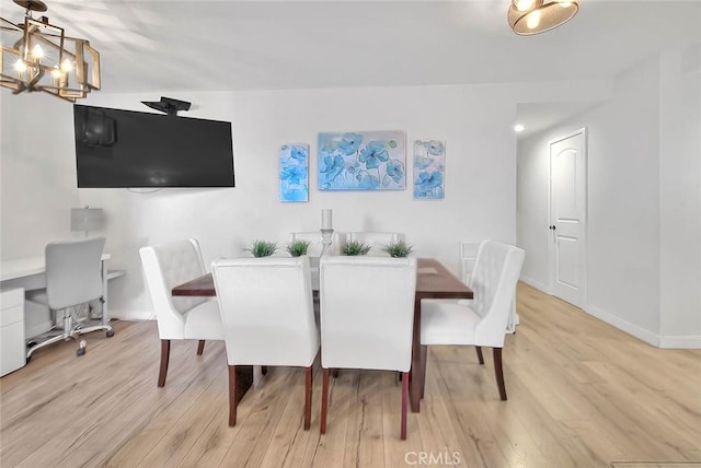 810 Edgewood St Unit 302, Inglewood, CA 90302 - dining room with light wood-style flooring, a chandelier, and baseboards