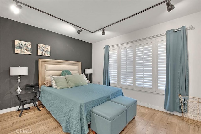 810 Edgewood St Unit 302, Inglewood, CA 90302 - bedroom featuring track lighting, light wood-style floors, and baseboards
