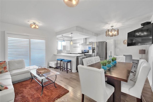 810 Edgewood St Unit 302, Inglewood, CA 90302 - dining area featuring a chandelier and light wood-style floors