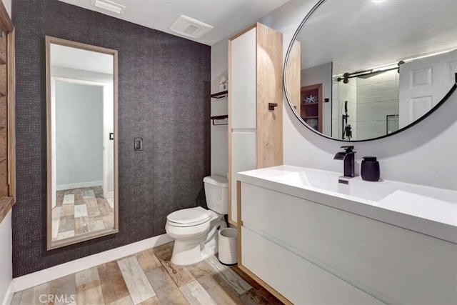 2815 E Coolidge Ave, Orange, CA 92867 - full bathroom featuring toilet, vanity, baseboards, wood finished floors, and a shower with door