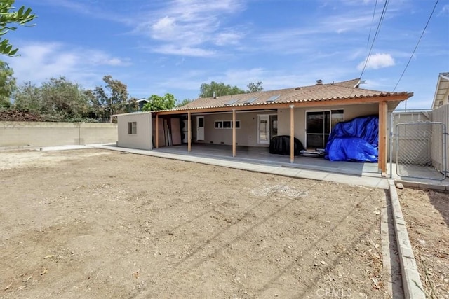 2815 E Coolidge Ave, Orange, CA 92867 - rear view of property with a patio, stucco siding, and a gate