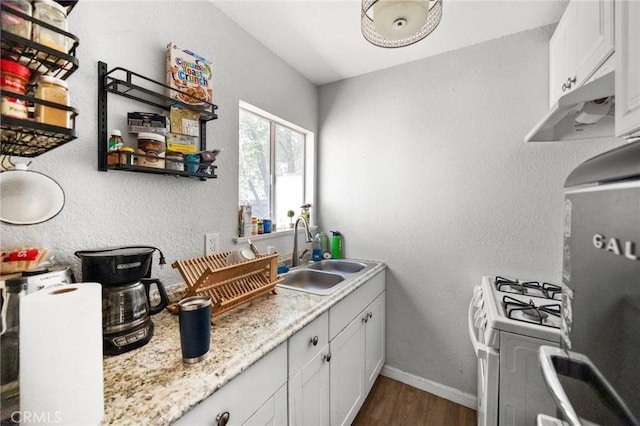632 Leebert Way, Crestline, CA 92325 - kitchen featuring a sink, white range with gas stovetop, refrigerator, dark wood-type flooring, and white cabinets