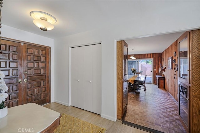 14242 Clarissa Ln, North Tustin, CA 92705 - entryway featuring wood walls, baseboards, and parquet floors