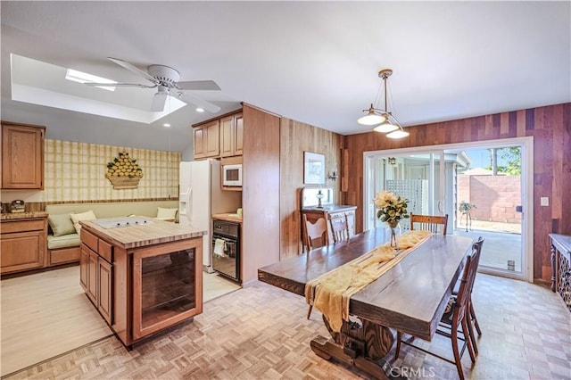 14242 Clarissa Ln, North Tustin, CA 92705 - dining area featuring ceiling fan, wallpapered walls, and wooden walls