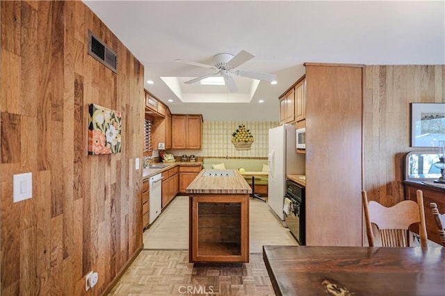 14242 Clarissa Ln, North Tustin, CA 92705 - kitchen with white appliances, a ceiling fan, a sink, butcher block counters, and wooden walls