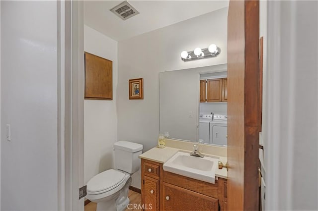 14242 Clarissa Ln, North Tustin, CA 92705 - bathroom featuring separate washer and dryer, vanity, and toilet