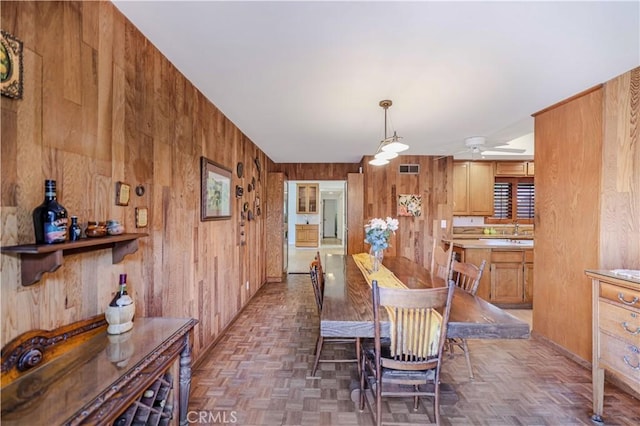 14242 Clarissa Ln, North Tustin, CA 92705 - dining room featuring wooden walls and ceiling fan