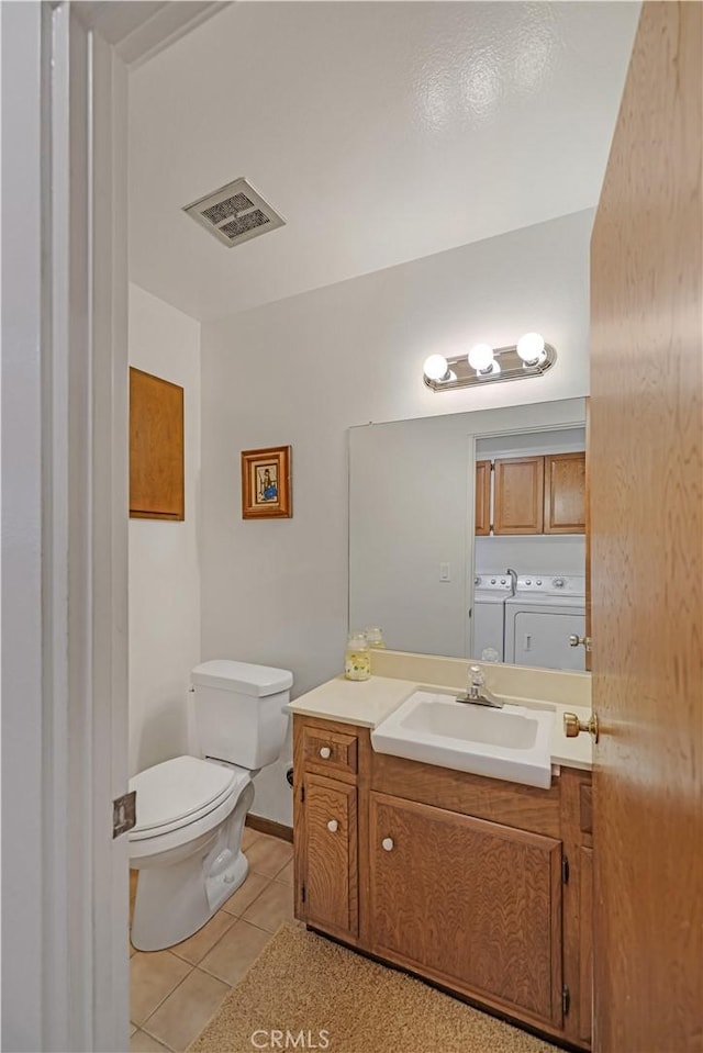 14242 Clarissa Ln, North Tustin, CA 92705 - bathroom featuring washer and dryer, tile patterned floors, vanity, and toilet