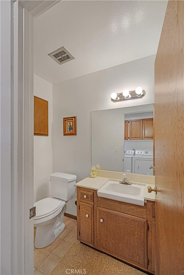 14242 Clarissa Ln, North Tustin, CA 92705 - bathroom featuring washing machine and dryer, tile patterned floors, and vanity
