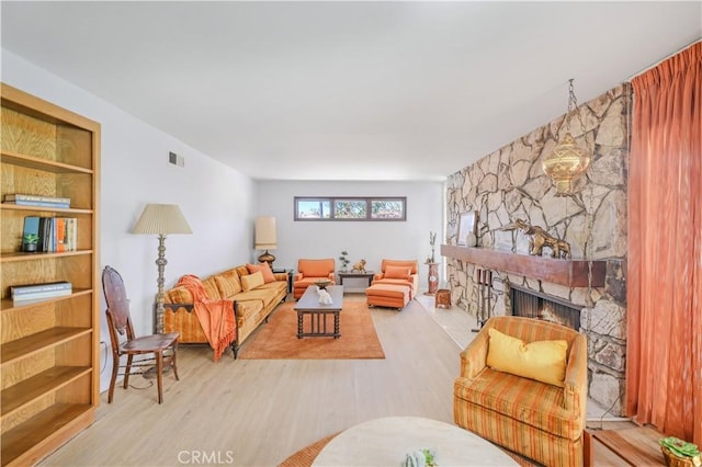 14242 Clarissa Ln, North Tustin, CA 92705 - living area featuring wood finished floors and a stone fireplace