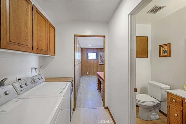 14242 Clarissa Ln, North Tustin, CA 92705 - laundry room with washing machine and clothes dryer, baseboards, and light wood-type flooring