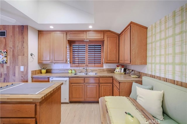 14242 Clarissa Ln, North Tustin, CA 92705 - kitchen with white dishwasher, a sink, wallpapered walls, light wood-style floors, and lofted ceiling