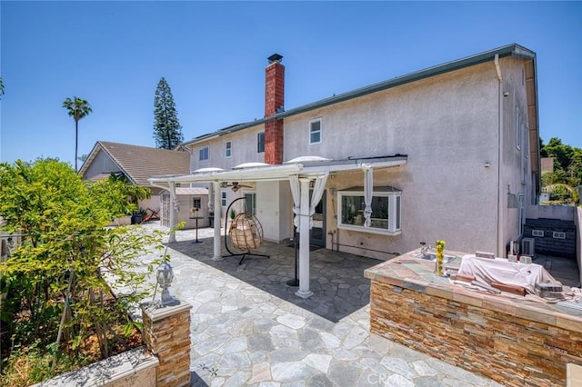 2160 S Hammatt, Anaheim, CA 92802 - back of property featuring a chimney, stucco siding, a patio, and a ceiling fan