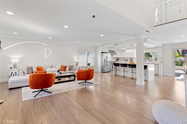 2160 S Hammatt, Anaheim, CA 92802 - living room featuring crown molding, light wood finished floors, recessed lighting, baseboards, and decorative columns