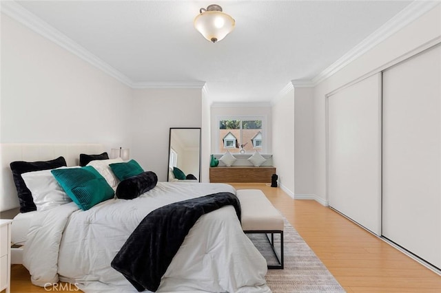 2160 S Hammatt, Anaheim, CA 92802 - bedroom with ornamental molding, light wood finished floors, and a closet
