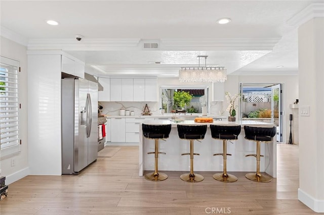 2160 S Hammatt, Anaheim, CA 92802 - kitchen featuring stainless steel refrigerator with ice dispenser, modern cabinets, crown molding, healthy amount of natural light, and white cabinetry