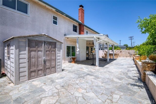 2160 S Hammatt, Anaheim, CA 92802 - rear view of house with a patio, a chimney, and stucco siding