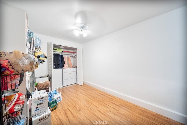 22123 Figueroa St Unit 144, Carson, CA 90745 - bedroom featuring baseboards, wood finished floors, separate washer and dryer, a closet, and a ceiling fan