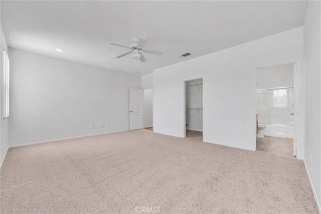 1760 Terrace Ave, Colton, CA 92324 - unfurnished bedroom featuring carpet floors, a walk in closet, ensuite bath, a closet, and a ceiling fan