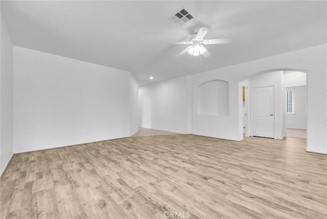 1760 Terrace Ave, Colton, CA 92324 - unfurnished living room featuring a ceiling fan, light wood finished floors, and arched walkways
