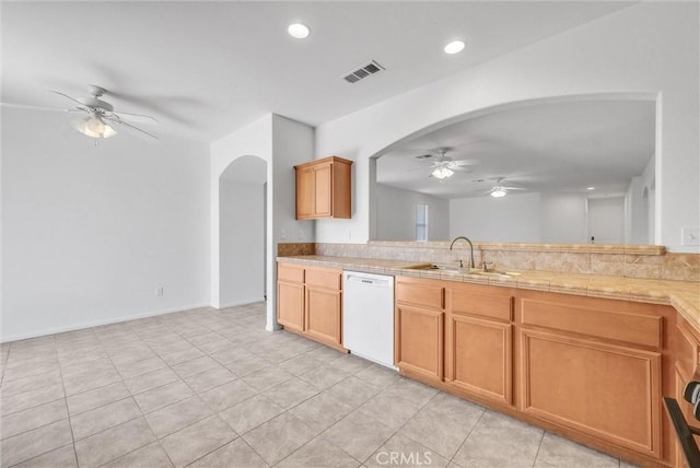 1760 Terrace Ave, Colton, CA 92324 - kitchen with a ceiling fan, dishwasher, arched walkways, light countertops, and light tile patterned flooring