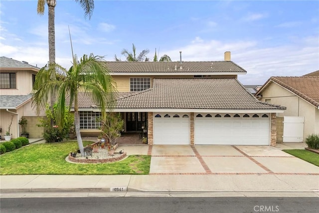 4541 Amberwood Ave, La Palma, CA 90623 - traditional home featuring a tile roof, driveway, a garage, and a front lawn